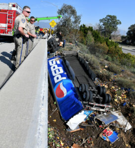 Pepsi truck flips over, trapping driver in Fontana